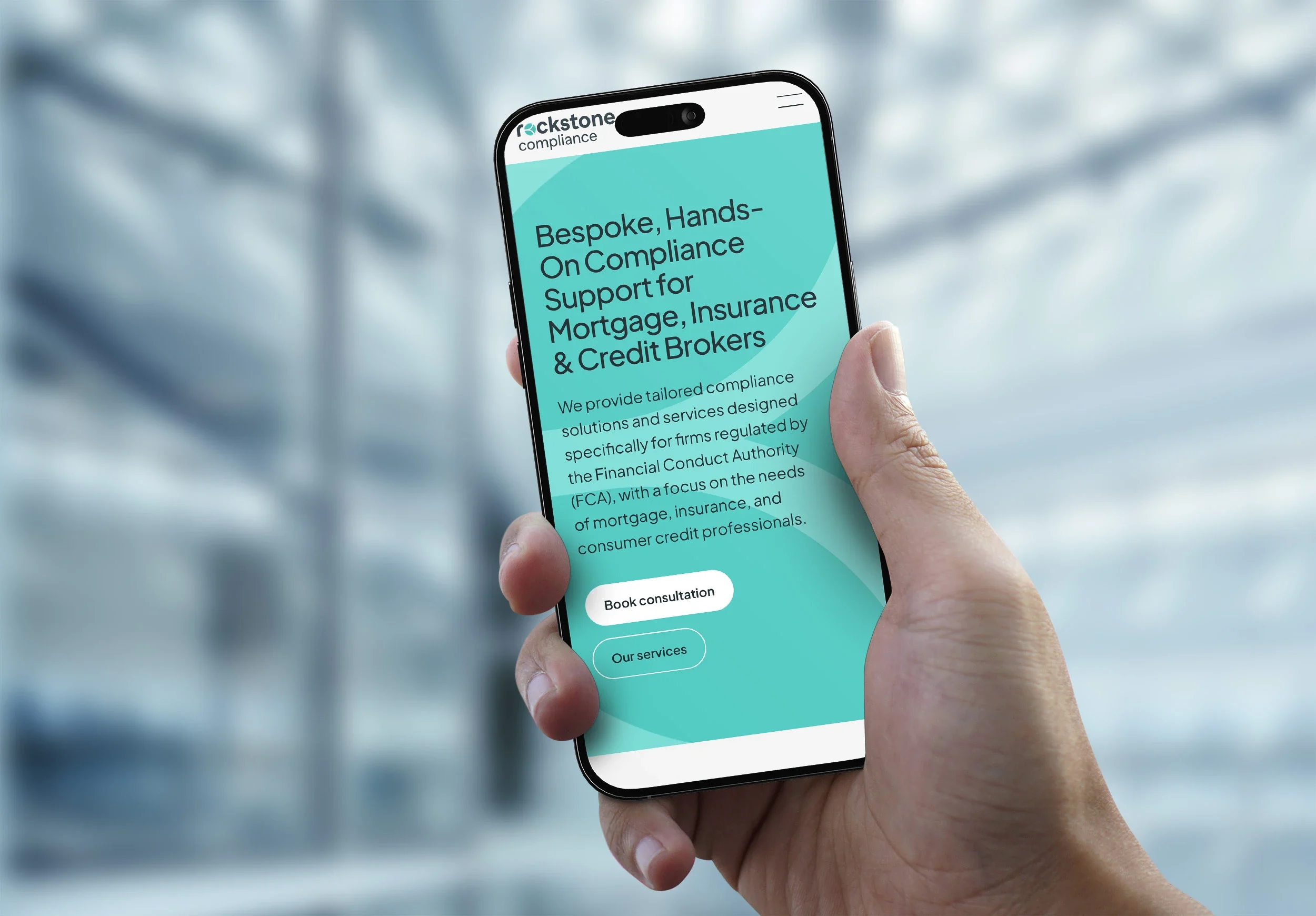 The Rockstone home page on a phone held in one hand