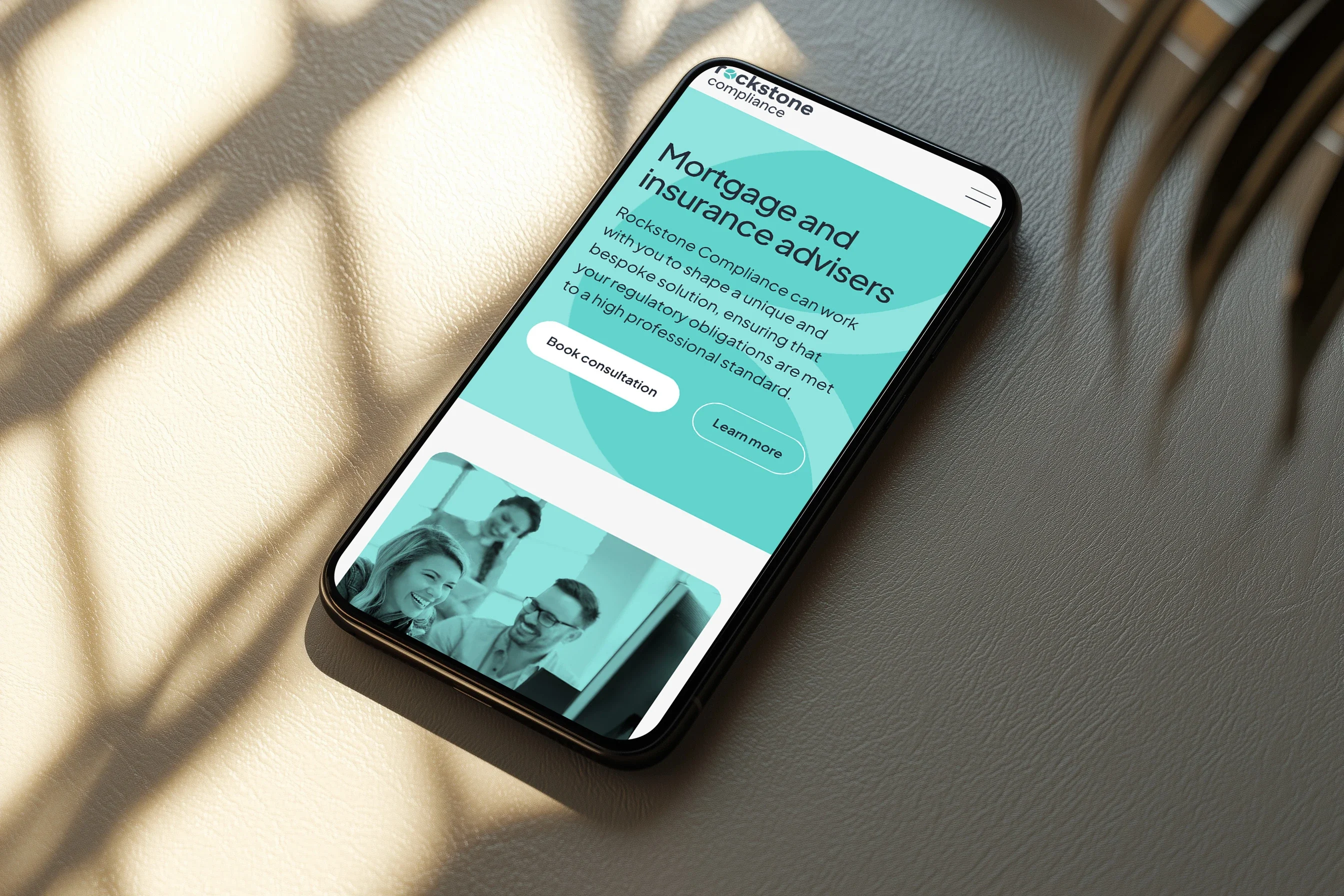 The mortgage and insurance advisers page on a phone, in sunlight