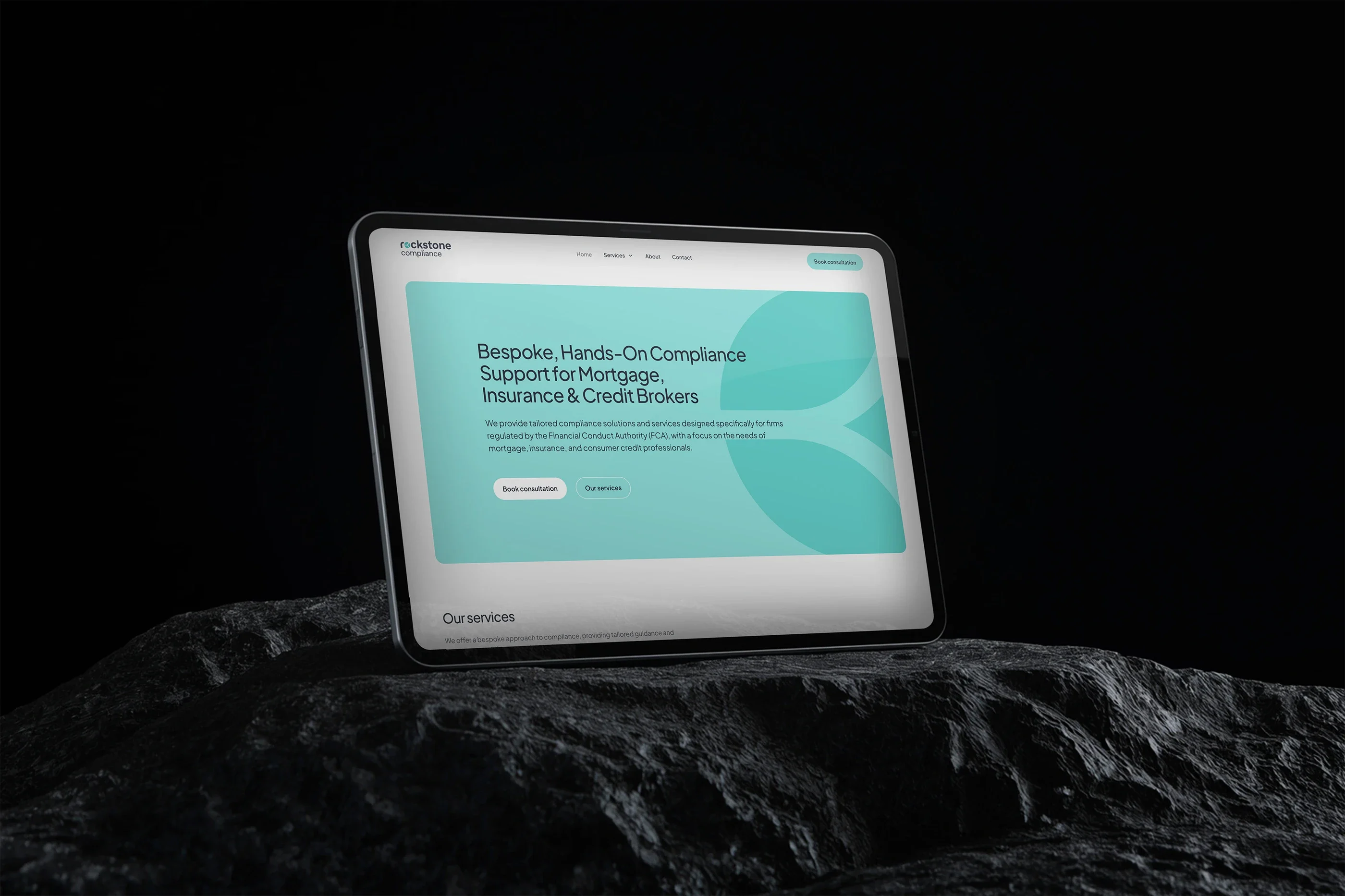 The Rockstone home page on a tablet resting on dark rock