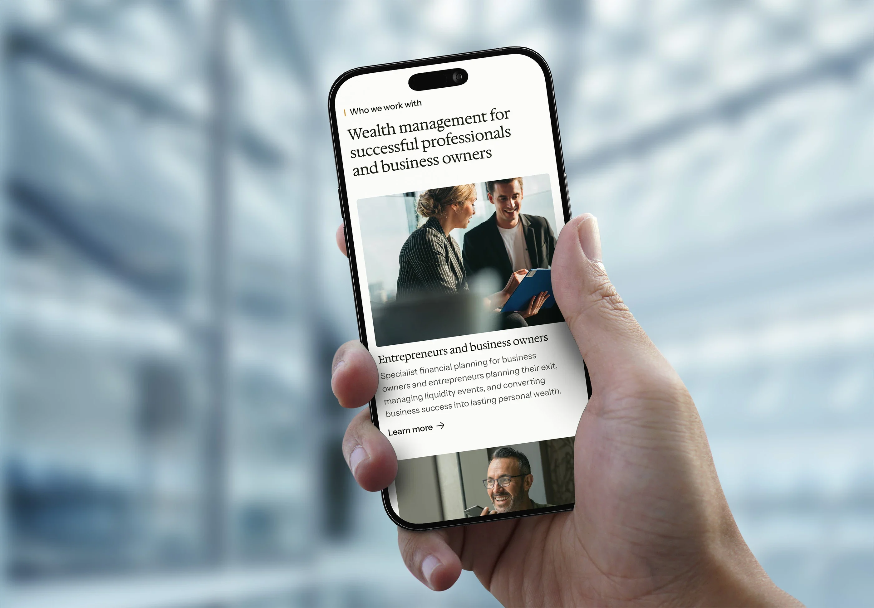The 'Who we work with' section on a phone held in one hand