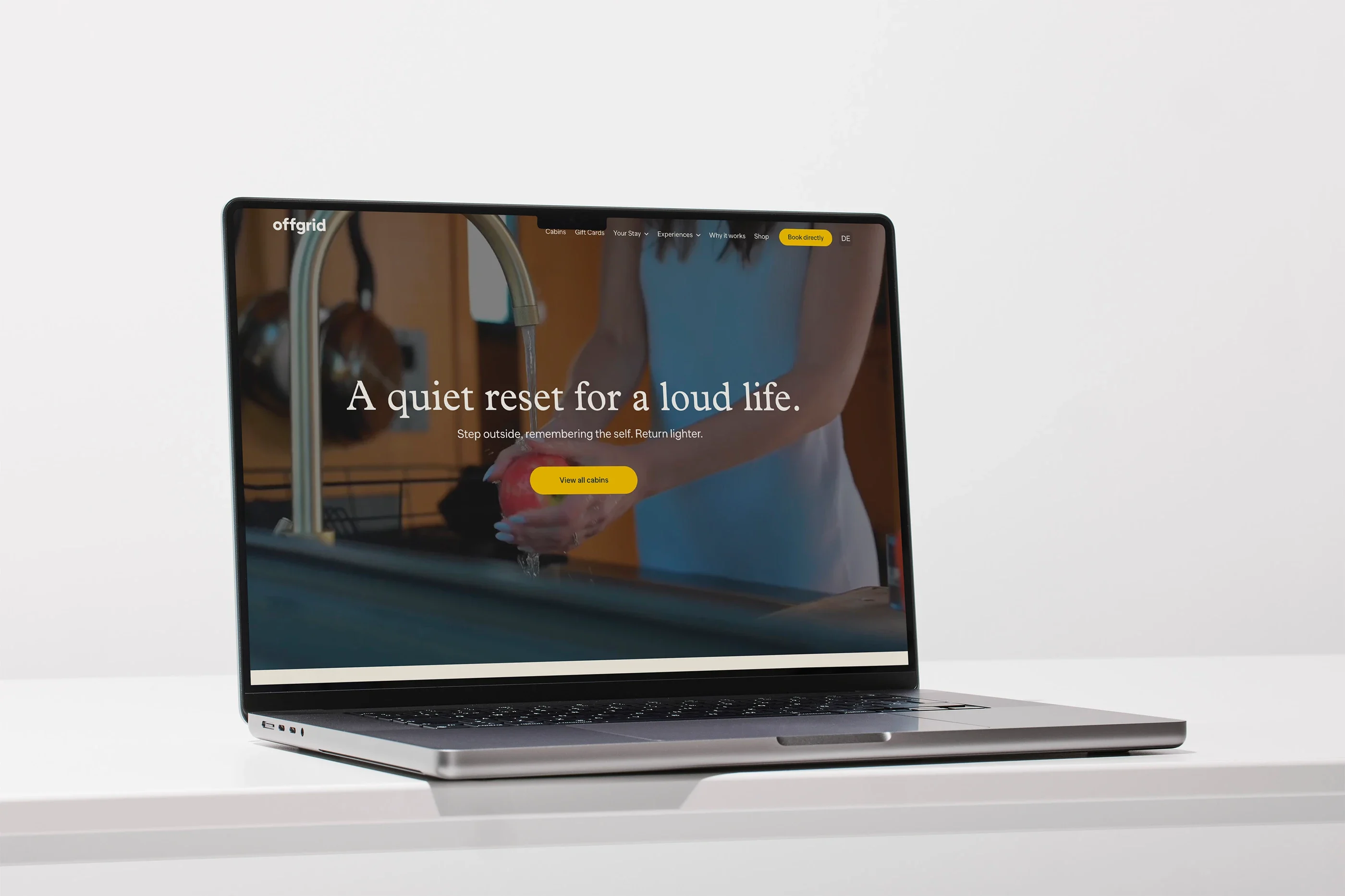 The Offgrid home page on a laptop: 'A quiet reset for a loud life'