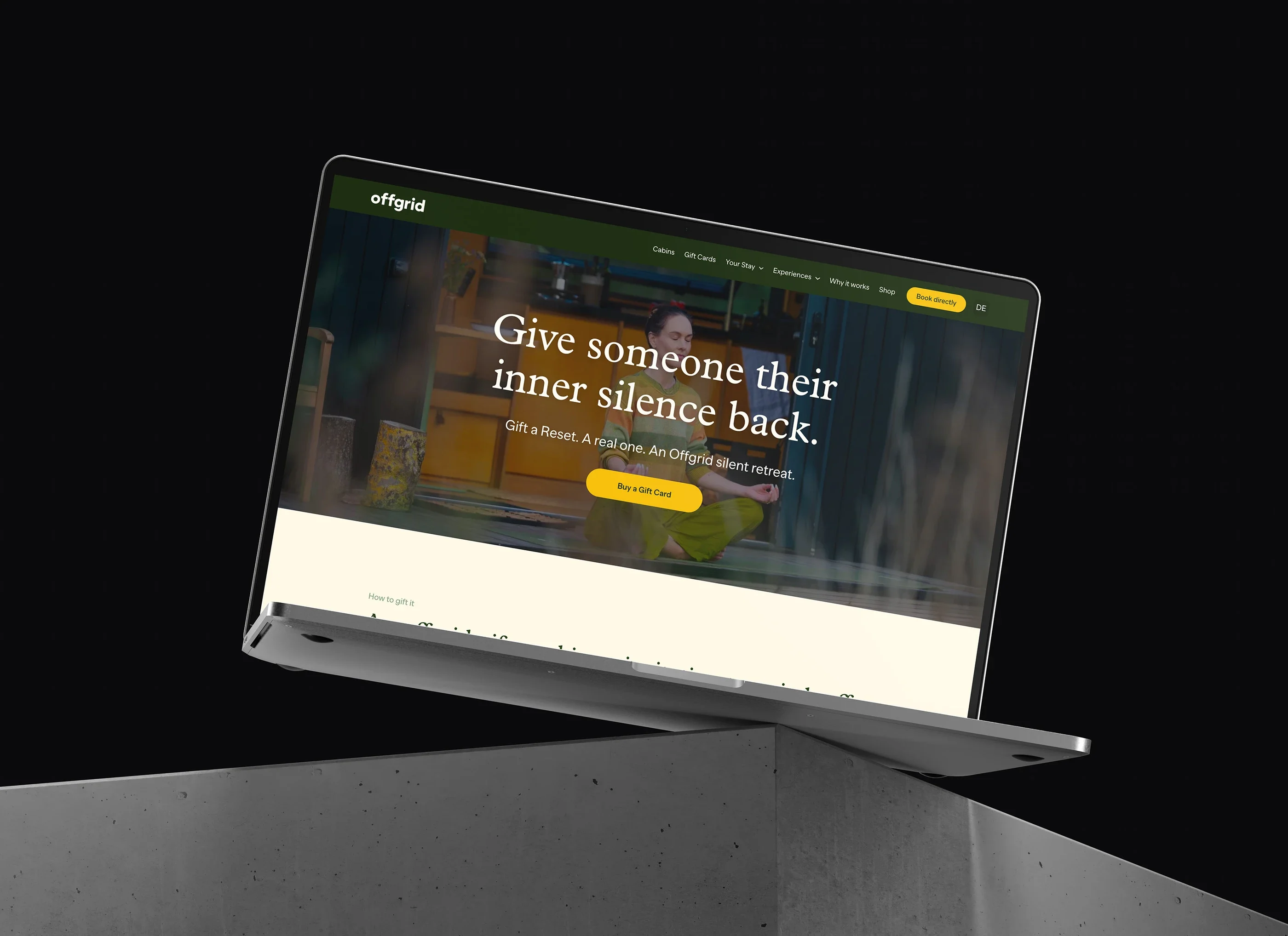 The gift cards page, 'Give someone their inner silence back', on a laptop against a dark background
