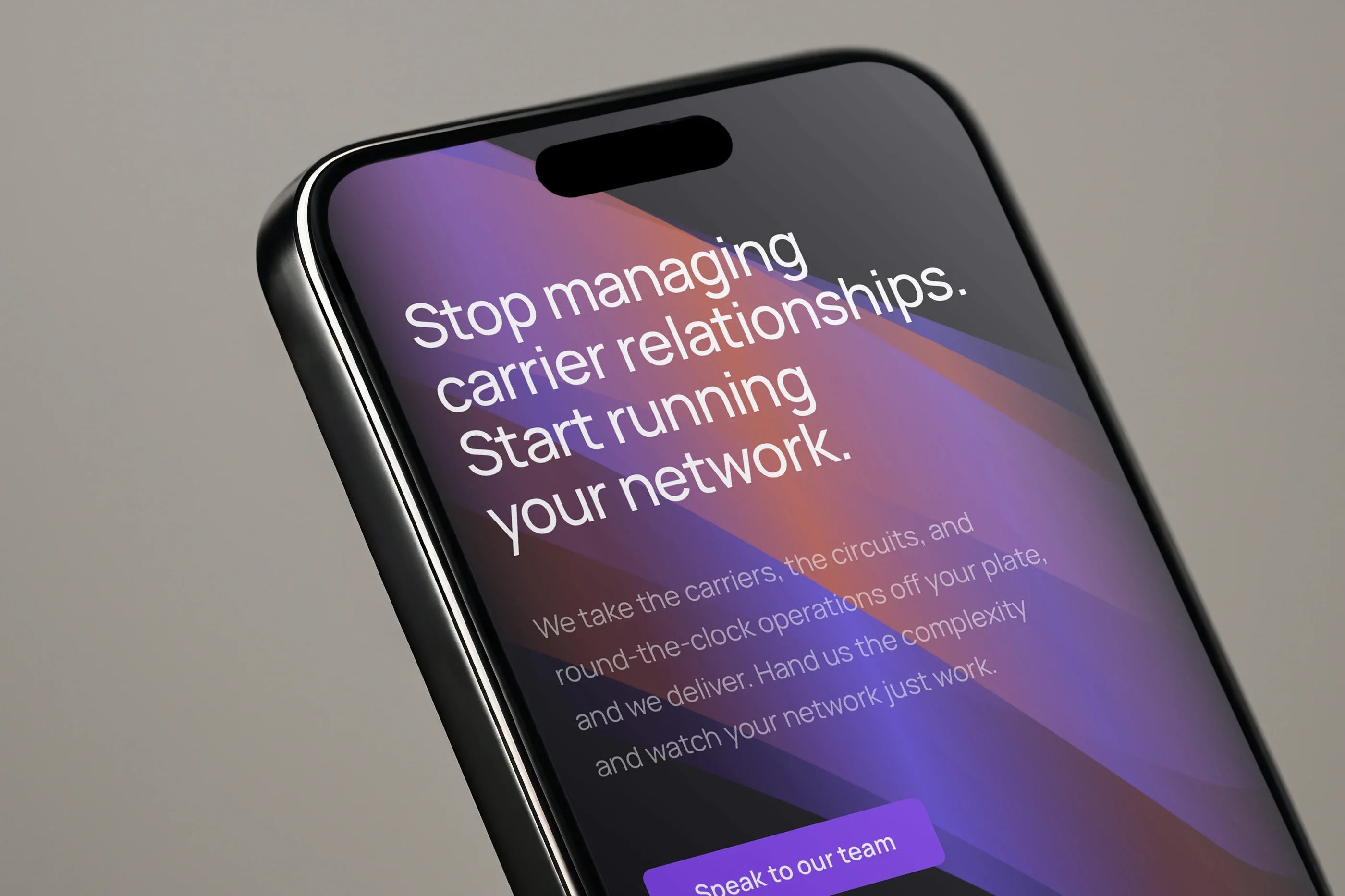 'Stop managing carrier relationships. Start running your network.' on a phone, close up