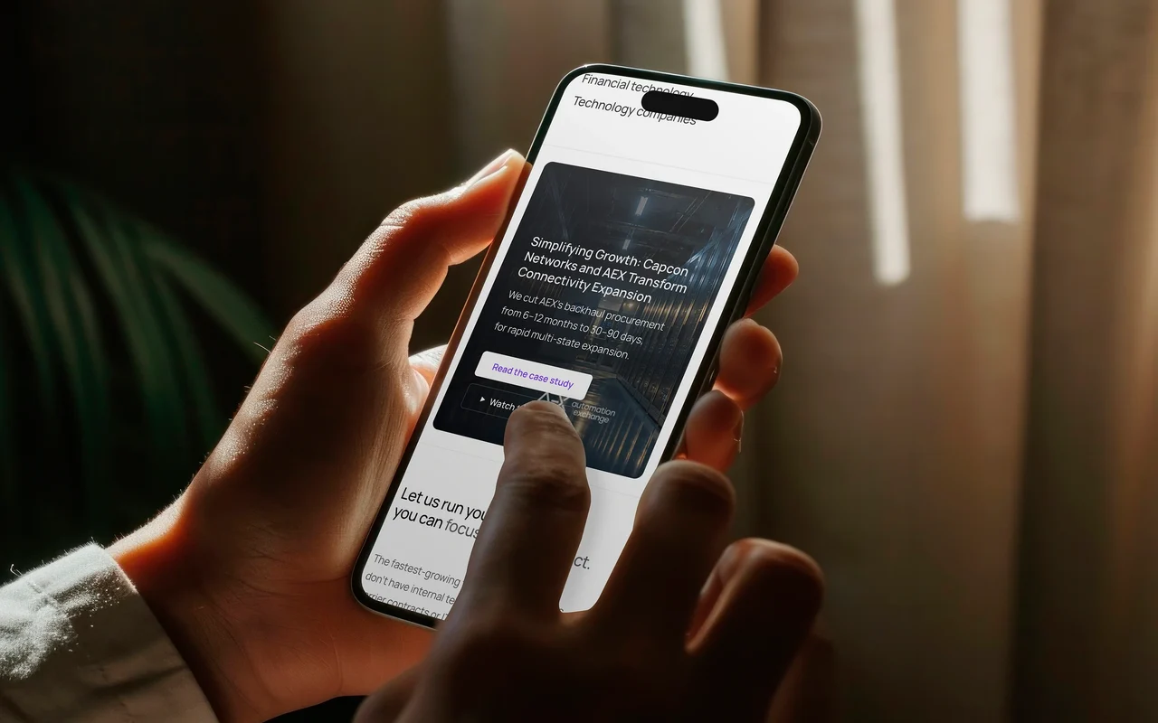 A customer story on the web-centric enterprise page, on a phone in warm light