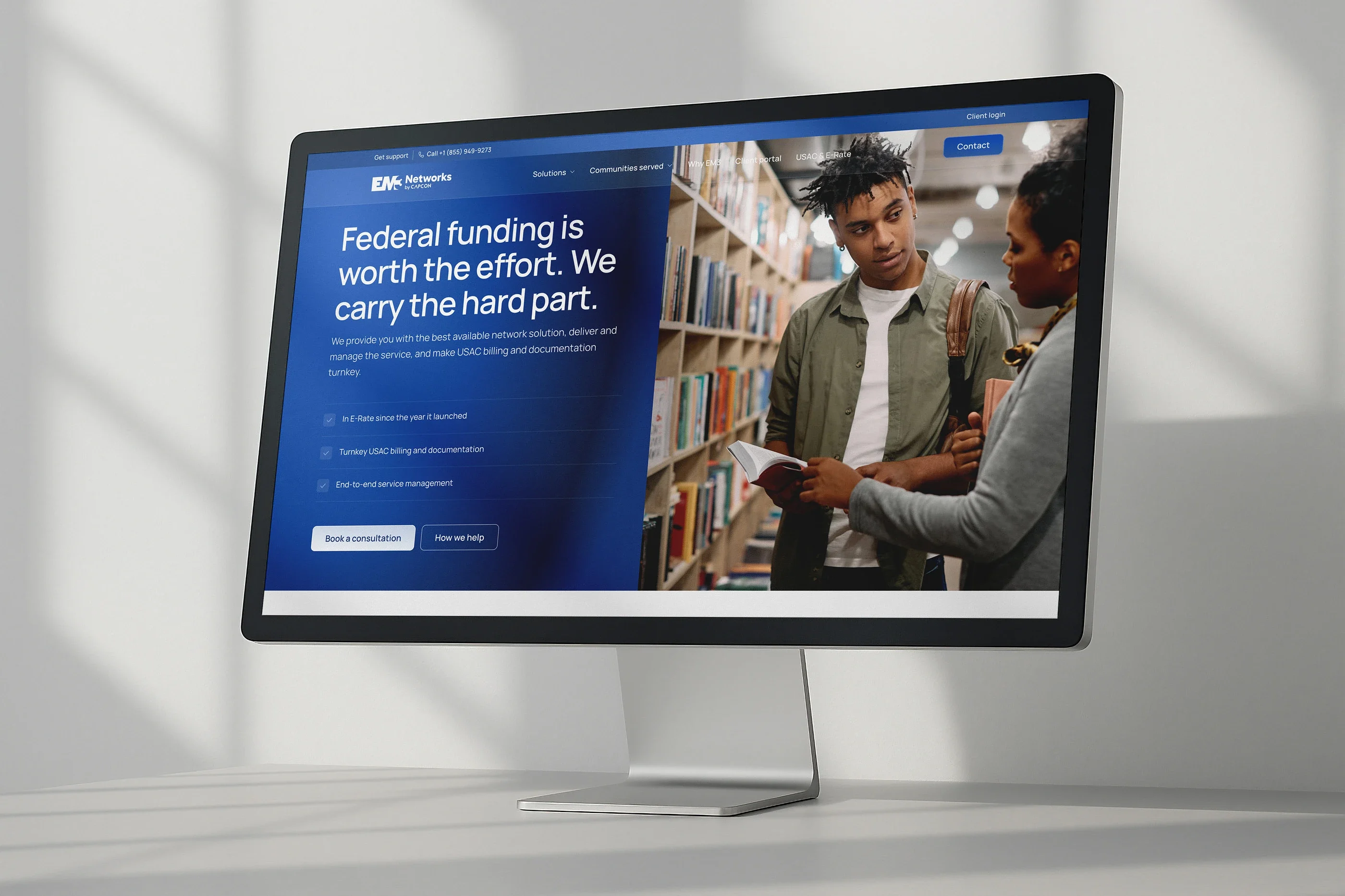The USAC & E-Rate page on a desktop monitor: 'Federal funding is worth the effort. We carry the hard part.'