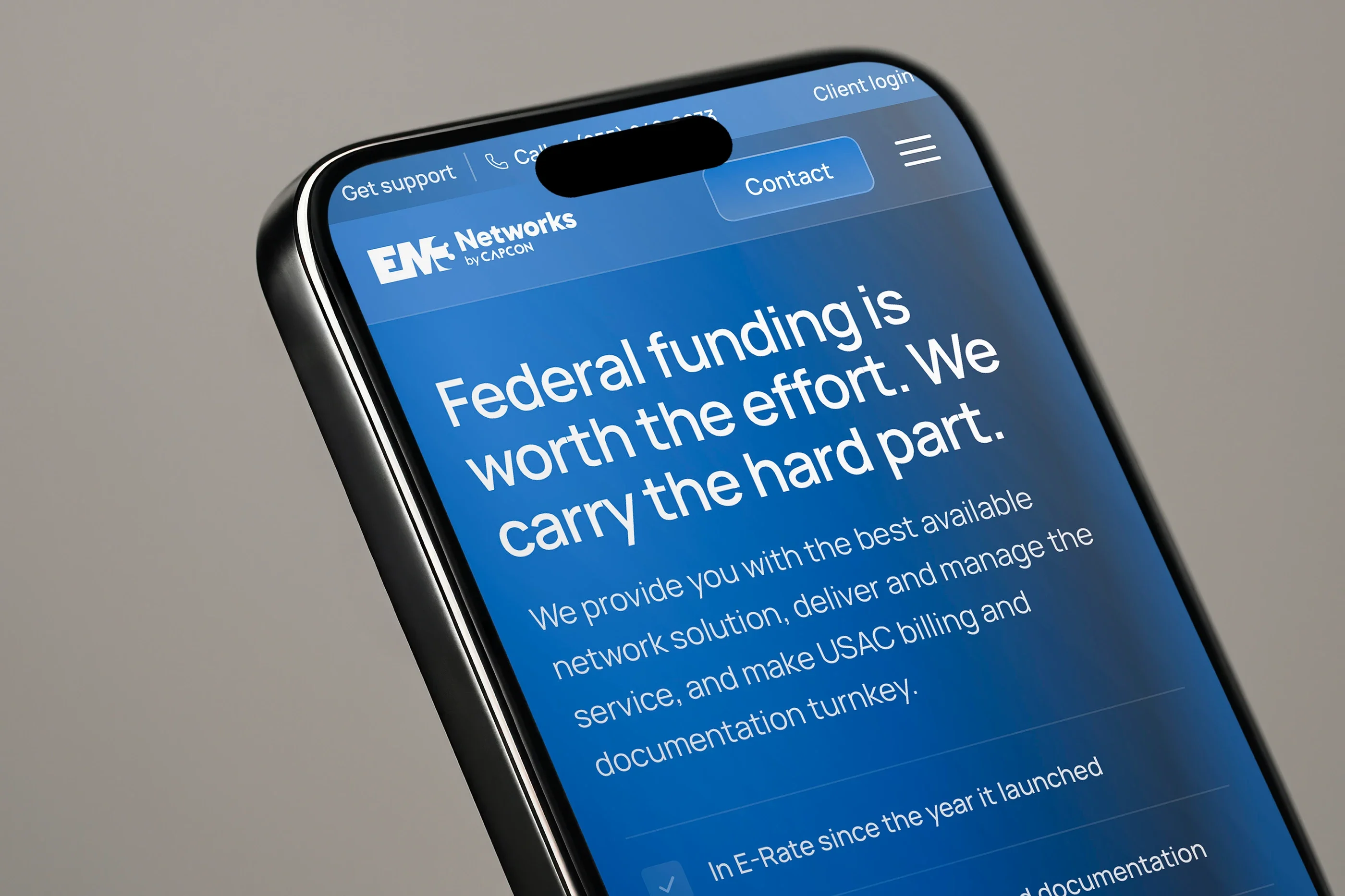 The USAC & E-Rate page on a phone, close up: 'Federal funding is worth the effort. We carry the hard part.'