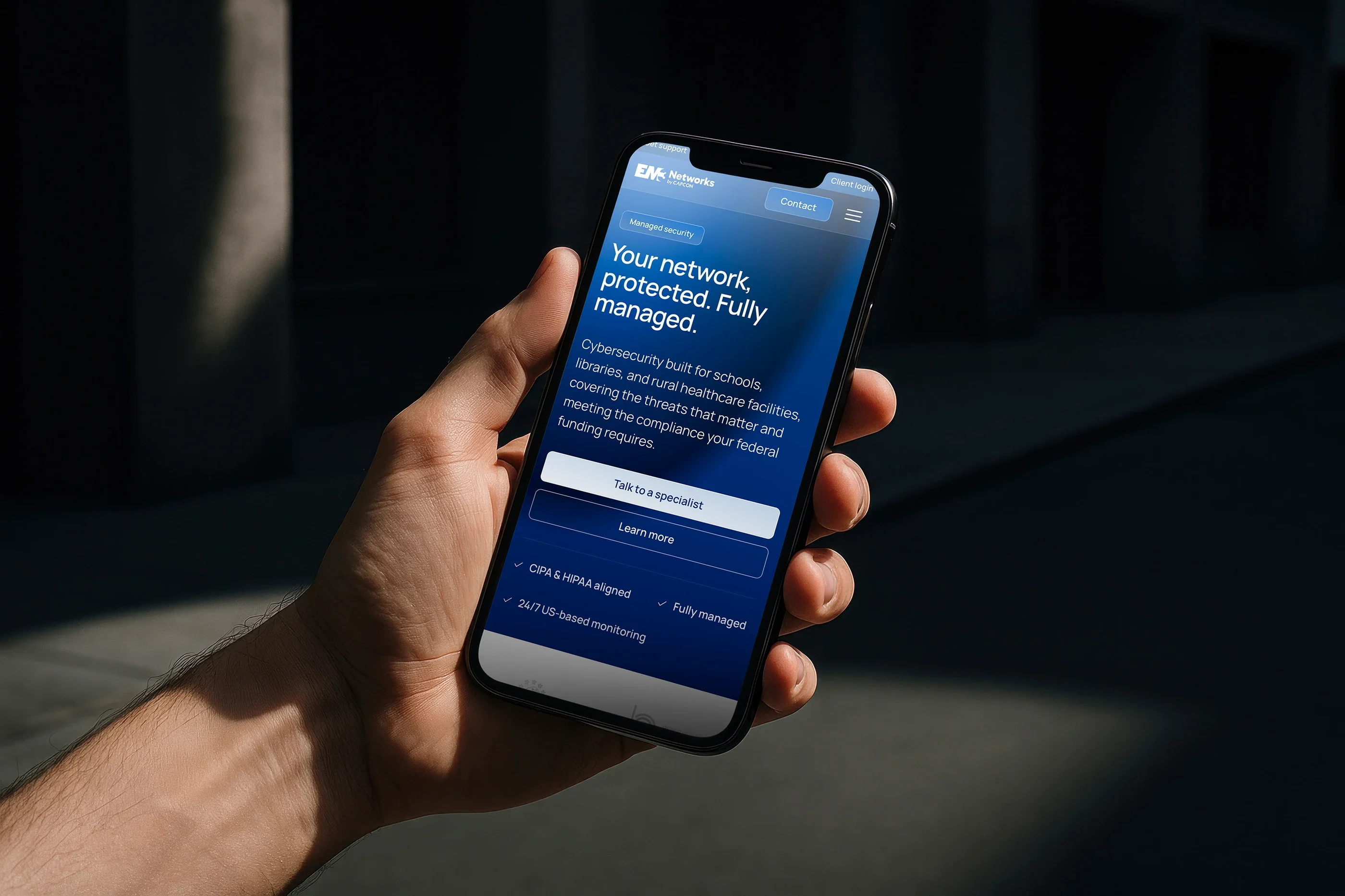 The Security page on a phone held in one hand: 'Your network, protected. Fully managed.'