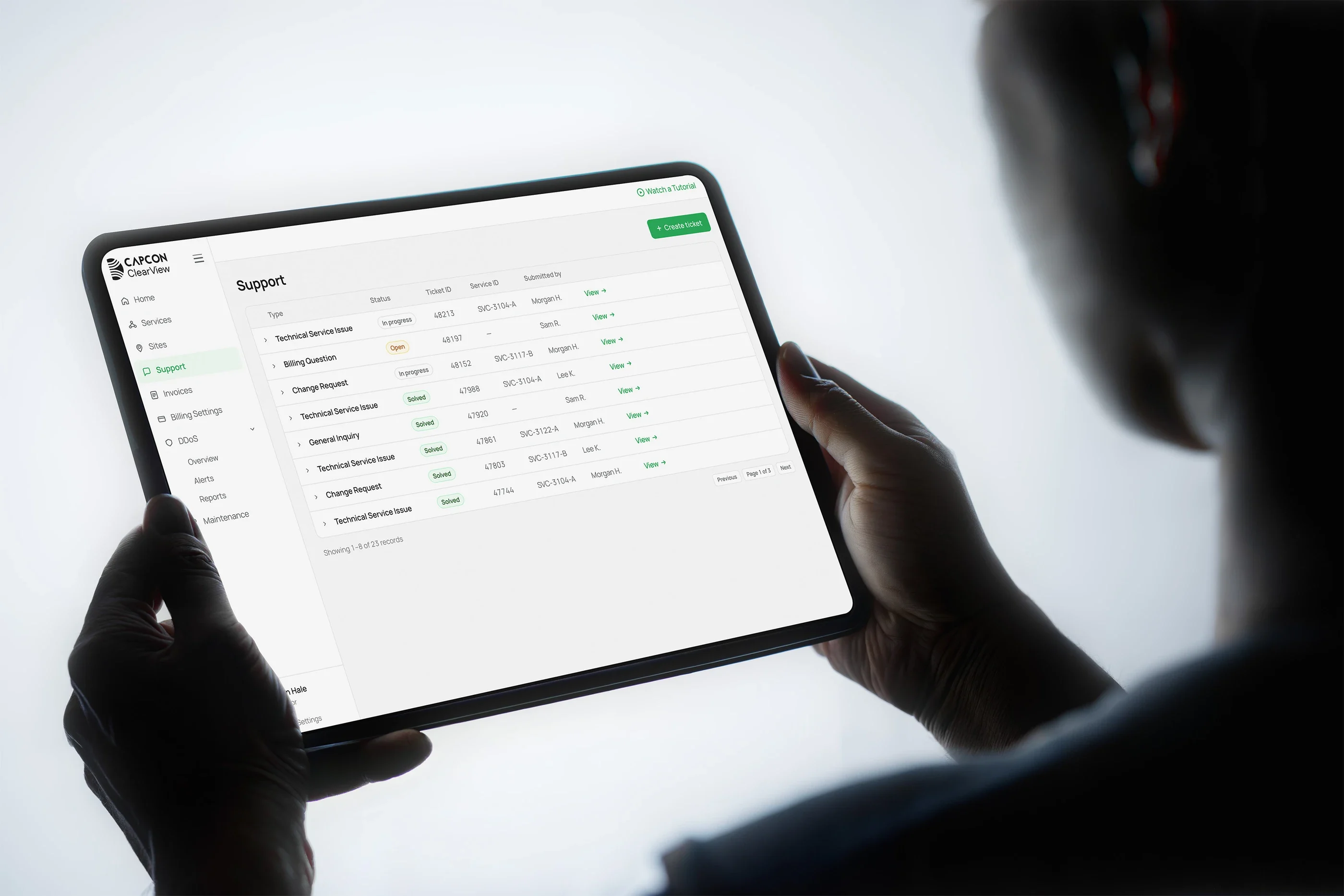 The support tickets list on a tablet held in two hands