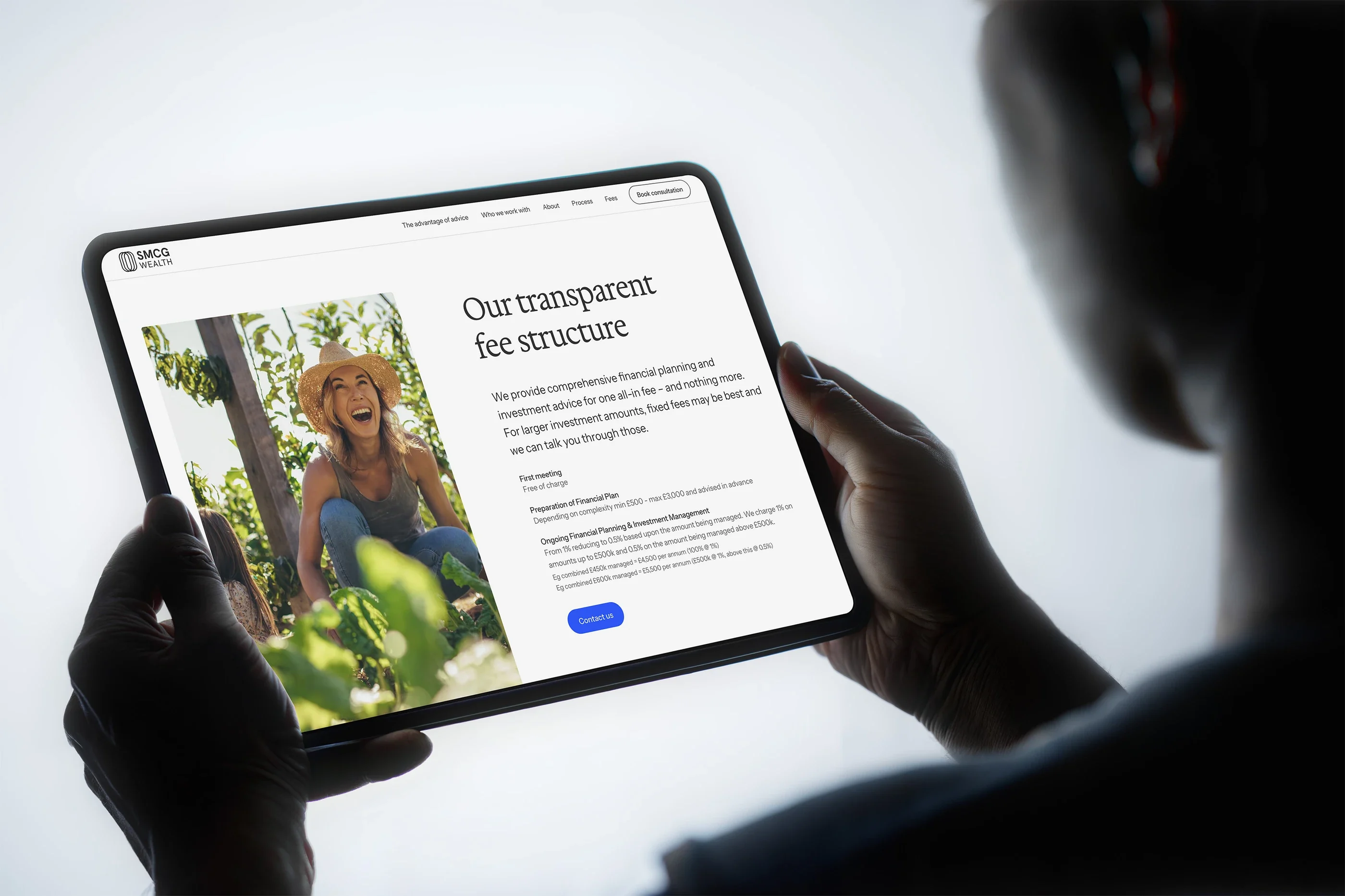 The fees page on a tablet held in two hands: 'Our transparent fee structure'