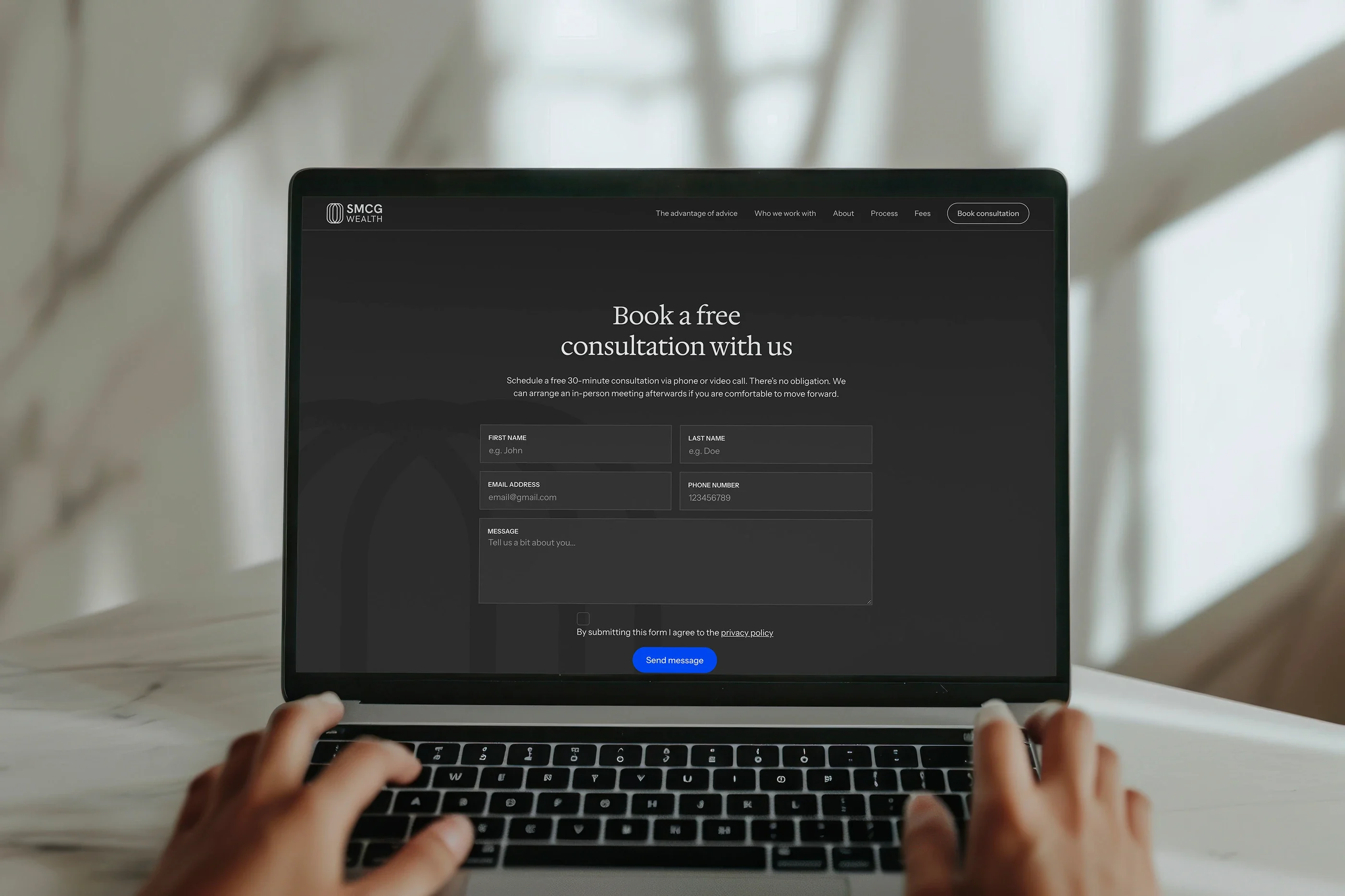 The contact page on a laptop: 'Book a free consultation with us', with the consultation form